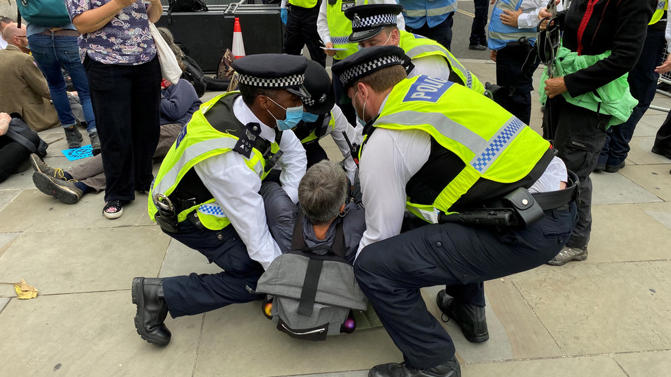 Extinction Rebellion activists glue themselves to street outside UK parliament as part of 10-day 'disruption'