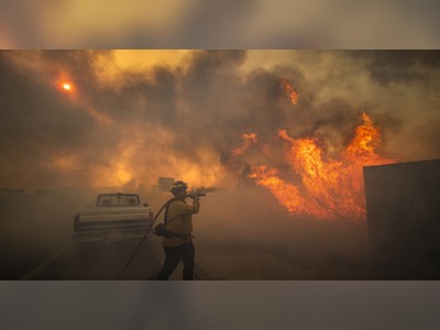 Fires sweep through Orange County, driving nearly 100,000 from their homes