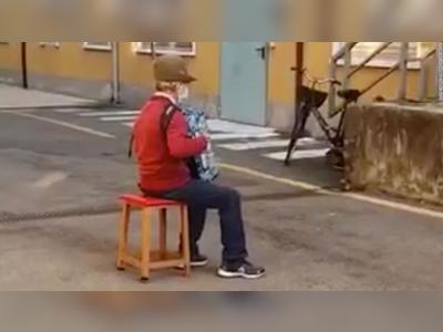 Italian man, 81, serenades his sick wife from outside hospital