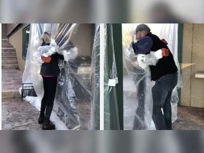 A Family Created A Plastic Shield So They Could Hug Each Other After Their Uncle Died Of COVID