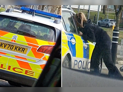 Two cops caught KISSING in car forced to apologise after driver films them