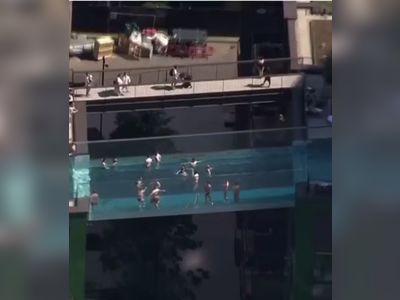 Londoners cool off in 'sky pool' suspended 115ft in the air between two buildings