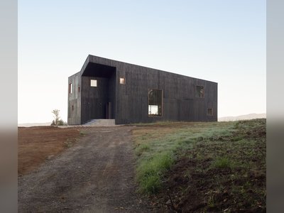 A Black Timber Home in Chile Echoes Local Volcanic Stone