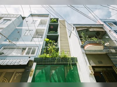 A Slim Green Home in Vietnam Rises Like a Tendril Out of Concrete