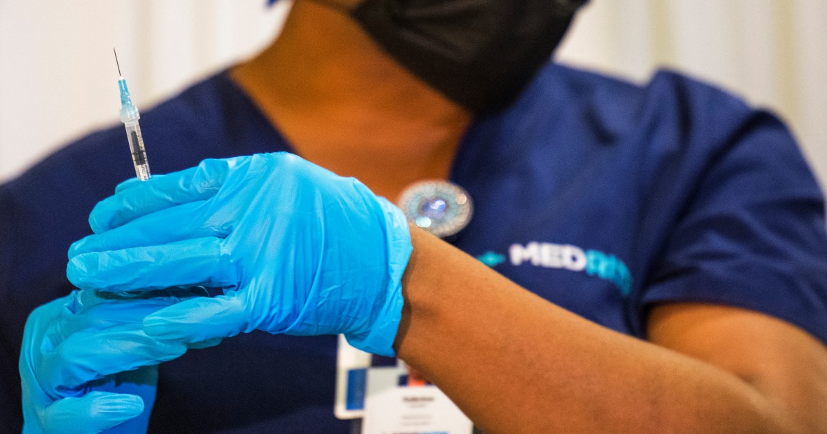 Medical staffer prepares vaccine dose