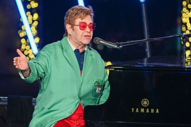 Sir Elton John and family step into Christmas as they surprise onlookers in NYC