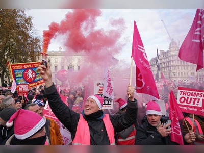 Thousands of striking Royal Mail workers stage rally near Parliament