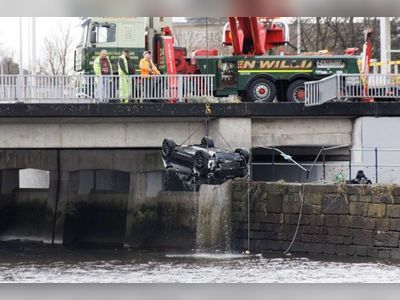 Two bodies found after BMW plunged into river