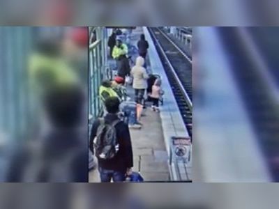 Woman arrested after girl, 3, pushed 'face first' onto train tracks