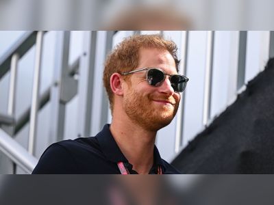Prince Harry all smiles as he steps out at US Grand Prix without Meghan Markle